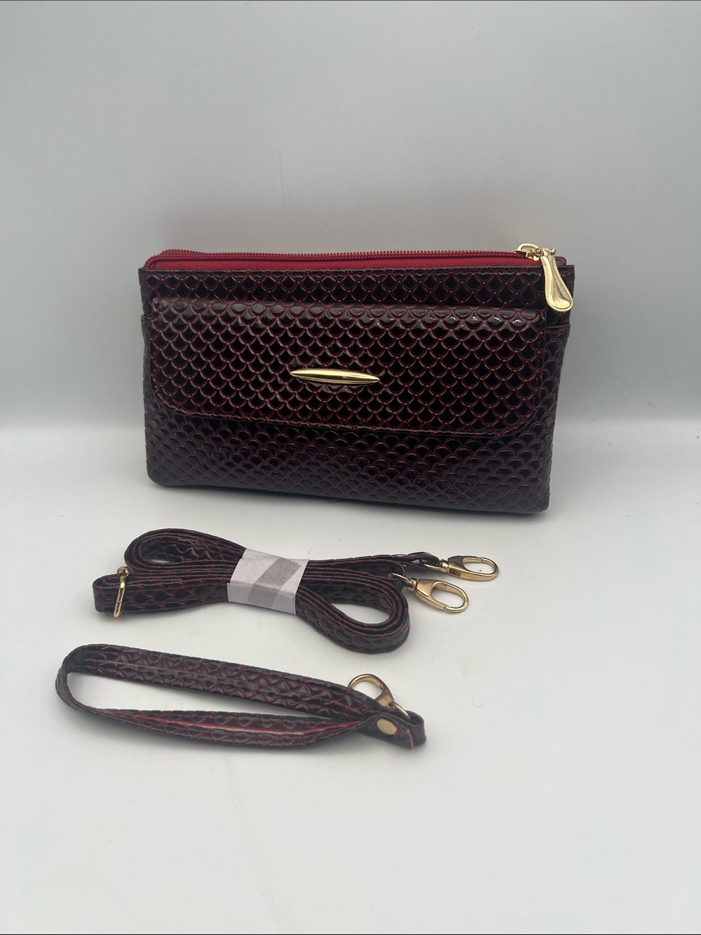 Compact Burgundy Textured Crossbody Bag with Gold Hardware